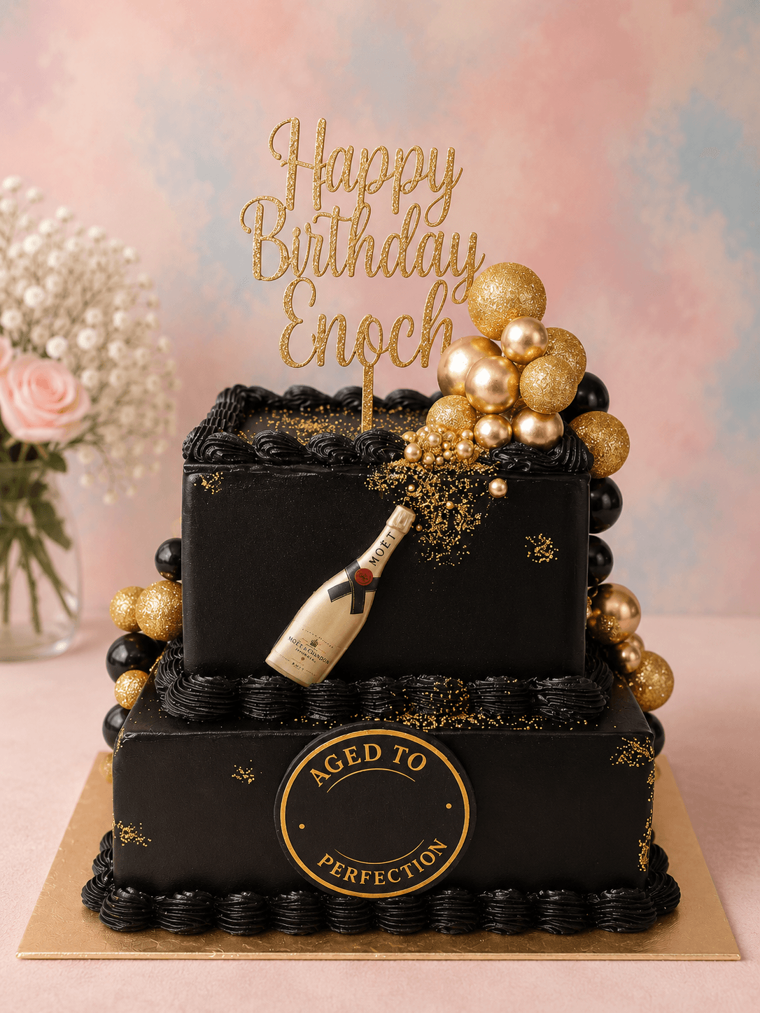 A black and gold birthday cake