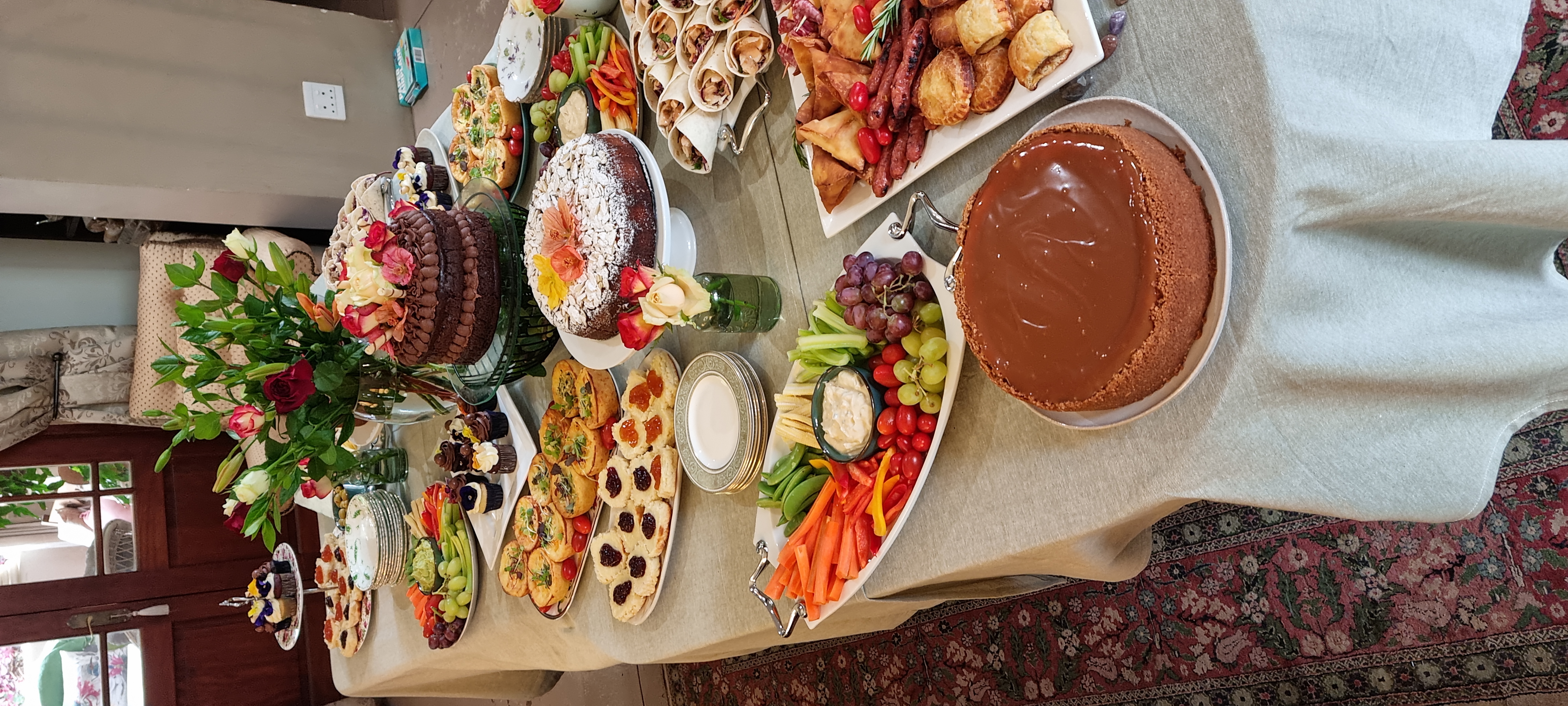 A table spread of homemade cakes, savouries and sweet treats